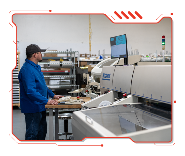 A D6 Labs technician at the MyData pick-and-place machine on our SMT line