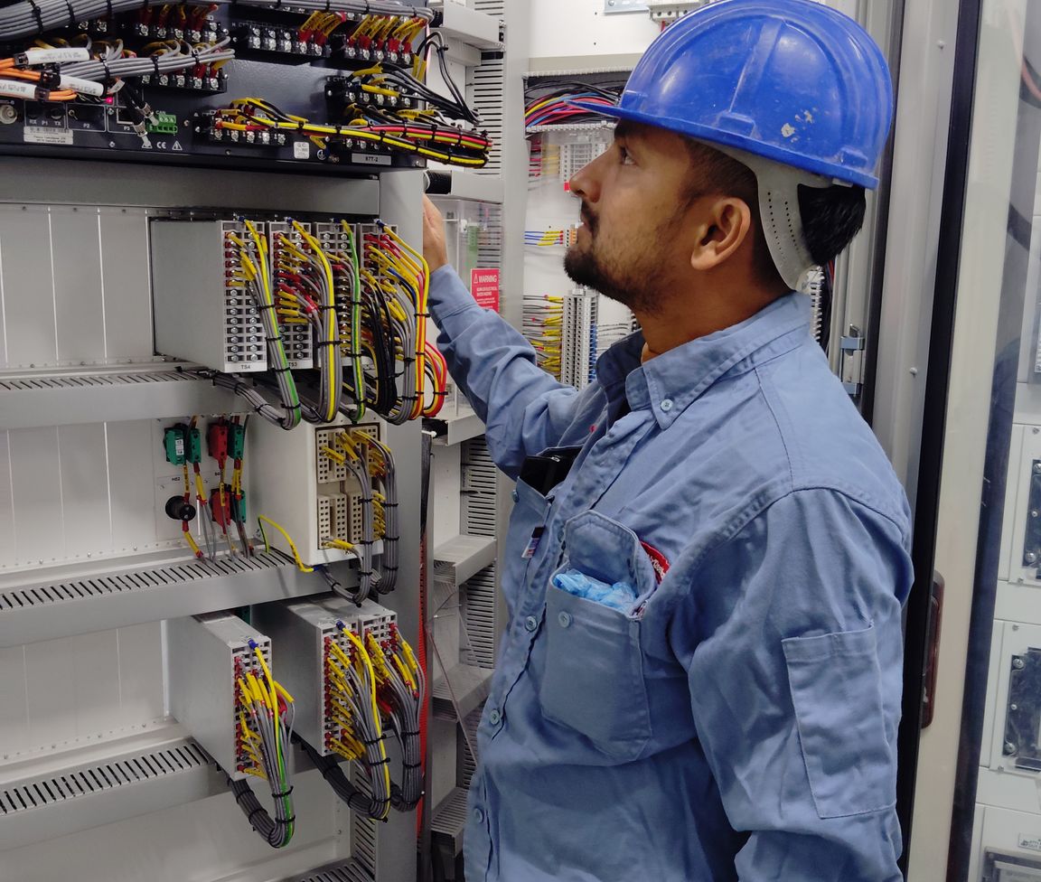 Pic of an installation technician wiring an industrial control panel